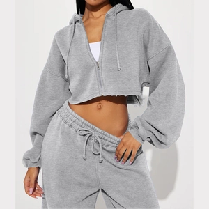 Detail of grey cropped zip-up hoodie and high-waisted joggers with raw hem finish
