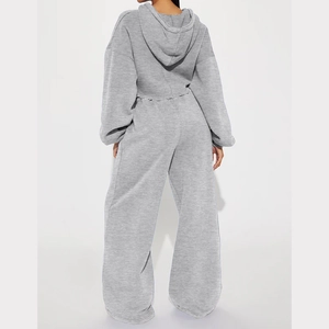 Rear view of a light grey knit lounge set featuring a cropped hoodie and wide-leg trousers
