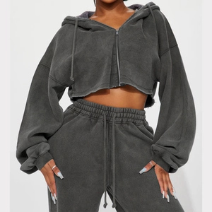 Detailed close-up of charcoal grey hooded sweatshirt and high-waist joggers set
