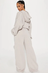 Back view of light grey women's two-piece tracksuit featuring hoodie and wide-leg joggers