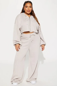 Detail of light grey two-piece tracksuit with cropped zip hoodie and wide-leg joggers