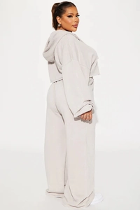 Detail of light beige cropped hoodie and wide-leg sweatpants set with soft fabric texture