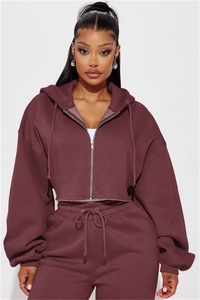 Detail of burgundy cropped zip-up hoodie and matching joggers with metal zipper