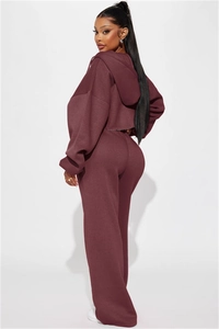 Detail view of the deep red two-piece tracksuit set with cropped hoodie and wide-leg pants