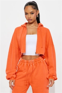 Detail of orange washed cotton hoodie and high waist joggers set with raw hem design
