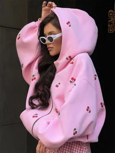 Detail of pink oversized zip hoodie with cherry print and thick fleece texture