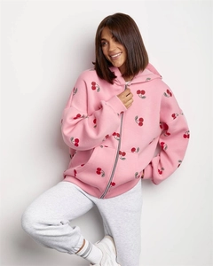 Detail of pink cherry print hoodie with soft knit texture and ribbed cuffs for fall