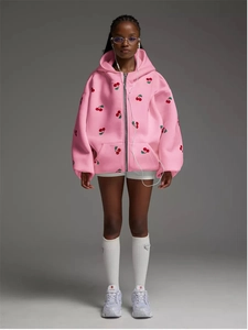 Detailed view of oversized pink zip-up hoodie with cherry embroidery and metallic zipper