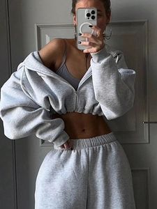 Detail view of light grey knit tracksuit with cropped zip hoodie and high-waisted joggers
