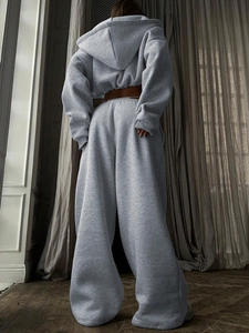 Back view of light grey oversized cropped hoodie and high waist wide leg sweatpants