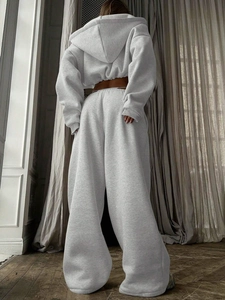 Detail of light grey cropped hoodie and high-waisted wide-leg sweatpants in soft knit