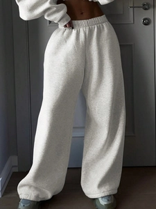 Detail of light gray marl high-waisted wide-leg sweatpants in soft knitted fabric