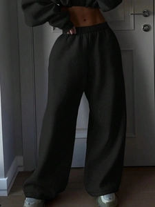 Detail of high-waist wide-leg pants and cropped hoodie set in black cotton blend