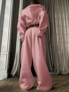 Rear view of pink two-piece tracksuit featuring a hooded sweatshirt and wide-leg joggers