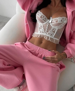 Detail of pink hoodie set featuring white lace polka dot camisole with frill trim edges