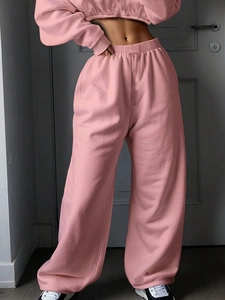 Detail view of pink long sleeve sweatshirt and matching high waist wide leg joggers set