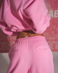 Close-up of pink tracksuit waist featuring a sparkling silver heart rhinestone chain belt