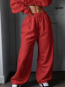 Detailed texture of vibrant red crop top hoodie and high-waisted wide-leg sweatpants set