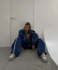 Detail of navy blue oversized hoodie and matching wide leg sweatpants with white stripes