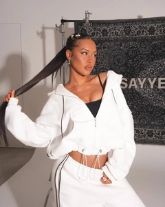 Detail of white cropped hoodie and jogger set with black contrast trim and drawstring