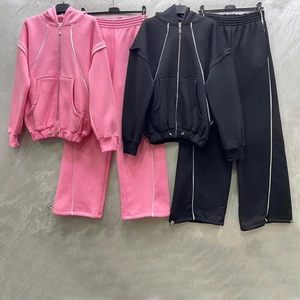 Detail view of contrast stripe stitching on drawstring hood and matching wide-leg joggers