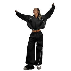 Women's black lounge set with white contrast piping, zip-up hoodie and wide-leg trousers