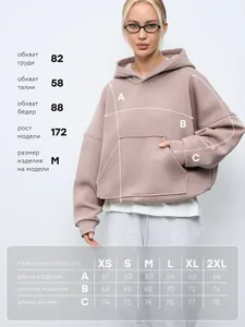 Size chart for cropped solid color drawstring hoodie with model measurements in centimeters