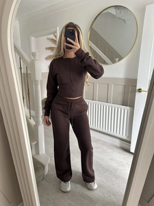 Detail of dark brown zip-up cardigan and matching high-waist straight-leg drawstring trousers