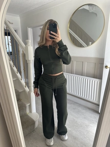 Detail of olive green tracksuit set with cropped zip hoodie and high-waist wide-leg pants