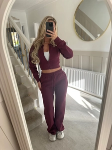 Mirror selfie showing a burgundy cropped zip-up hoodie and high-waist wide-leg pants set