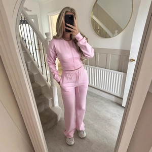 Pink two-piece casual lounge set with zip-up long sleeve jacket and wide leg pants