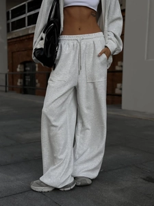 Detalle del conjunto deportivo gris con cintura ajustable y bolsillos de carga