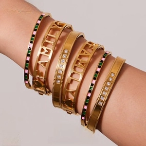 Macro shot of 18K gold plated stainless steel bracelets with zircon and colorful enamel