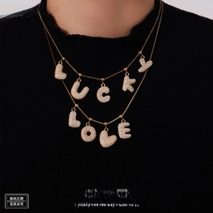 Double-layered 18K gold plated necklace featuring sparkling LUCKY and LOVE letter charms