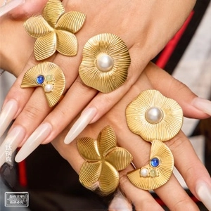 Macro view of gold plated titanium rings set with blue gemstones and white pearls
