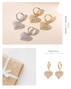 Detailed macro view of heart-shaped drop earrings featuring white zircon pavé setting