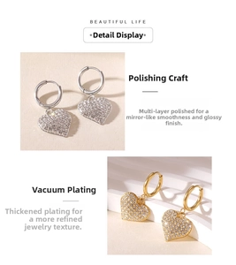Detail of heart drop earrings with white zircon in gold and silver plating