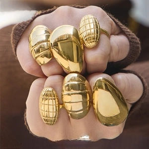 Macro shot of titanium steel gold plated rings with geometric textures and patterns
