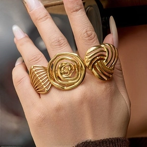 Detailed macro view of 18k gold plated titanium steel floral rings with non-fade finish