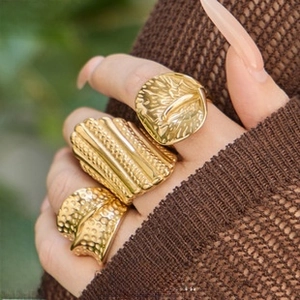 Three assorted 18K gold plated stainless steel rings with hammered and ribbed textures