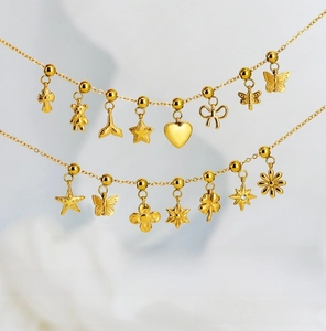 Macro shot of 18K gold plated charms including butterfly, heart, and bear shapes