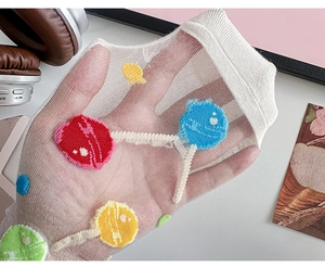 Close-up of sheer mesh socks featuring colorful lollipop embroidery for a trendy look