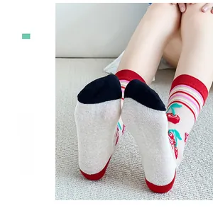 Detail of sheer crystal socks with cute cherry print and colorful striped cuffs