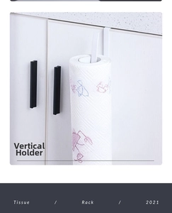Vertical white kitchen paper towel rack mounted on a modern cabinet door detail view