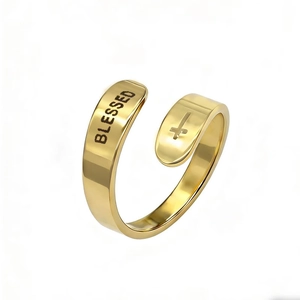 Macro shot of gold stainless steel ring with BLESSED text and cross symbol engraving