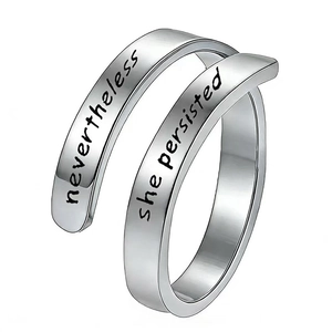 Detail of silver stainless steel ring featuring engraved nevertheless she persisted text