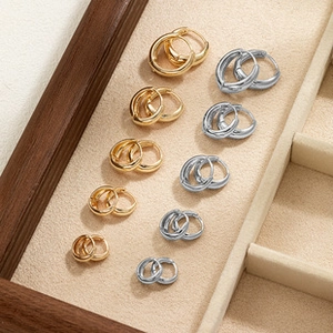 Polished gold and silver hoop earrings in various sizes displayed on a jewelry tray