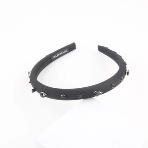 Handmade black sponge headband featuring matte fabric and sparkling star embellishments