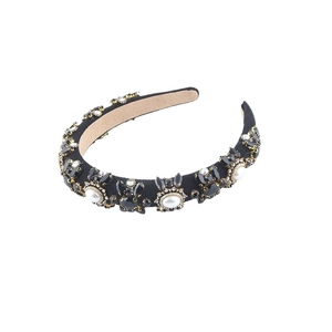 Luxurious black sponge headband with oversized pearls and rhinestones on white background