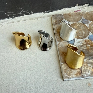 Irregular wide open rings in polished and brushed gold and silver finishes on stone